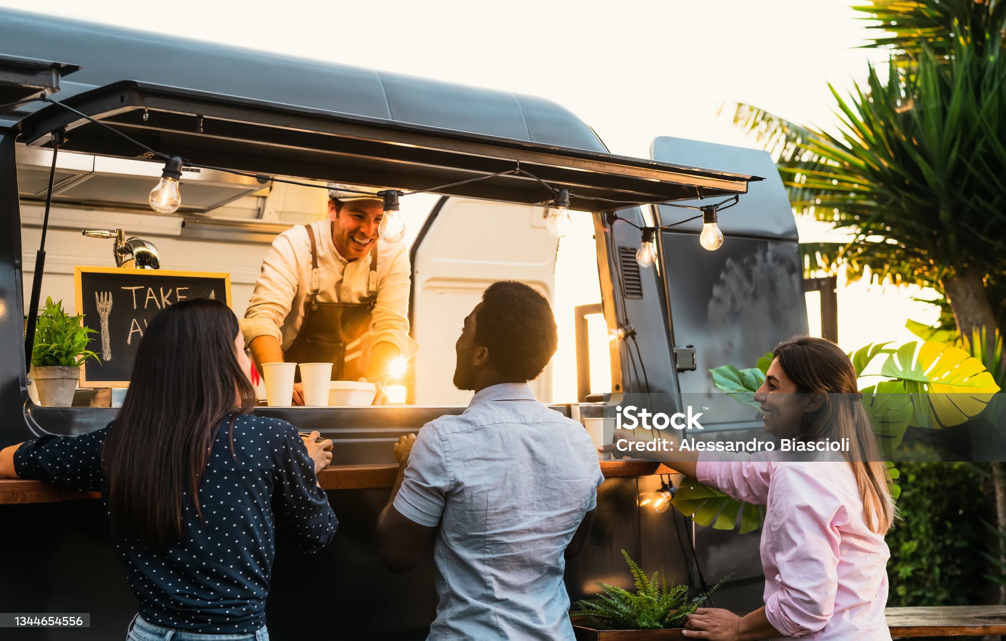 Placeholder image of a group standing at a food cart.