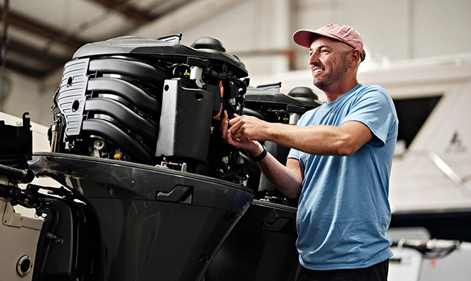 A man working on a boat engine