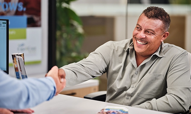 A client shaking a Cape and Coast employees hand