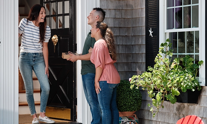 A couple visiting a neighbor with food