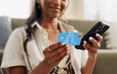 A woman entering her card information on her phone