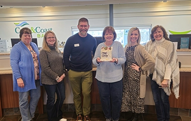 Sandwich branch team members celebrate 20th employment anniversary.