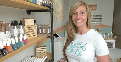 A small business owner posing by her products