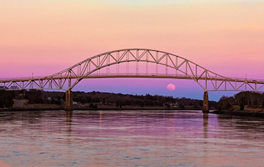 A bridge over the coast at sunset