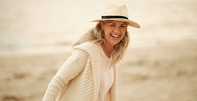 A woman laughing on the beach