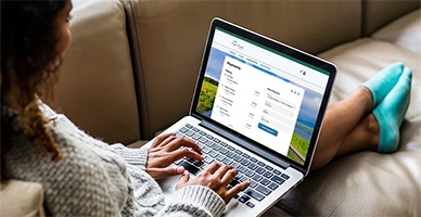 A woman on her online mobile banking platform on a laptop