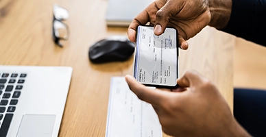 A person taking a picture of a check for mobile deposit
