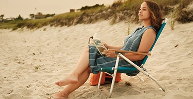 A woman sitting in a beach chair
