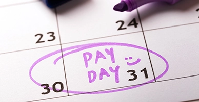A calendar with pay day circled