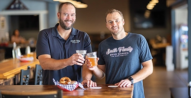Two customers cheersing at a restaurant