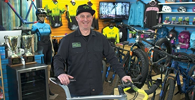 Owner of Bike Zone in Hyannis stands in front of bike in his shop