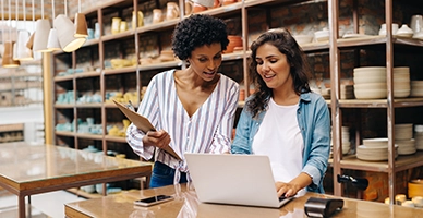 Earthday Landscaping family team pose in front of heavy equipment.