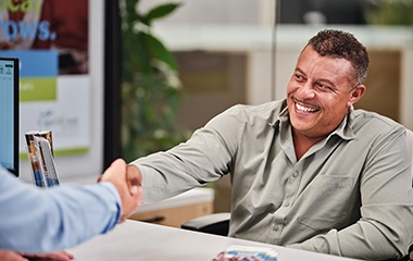 A Cape Cod employee shaking a clients hand