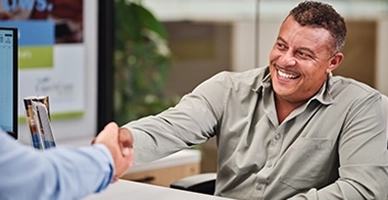 A client shaking a Cape and Coast employees hand