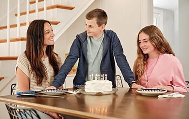 A family singing happy birthday to their son