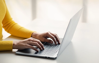 Someone typing on their laptop