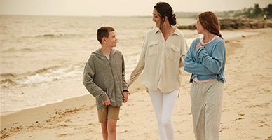 A family walking down the beach