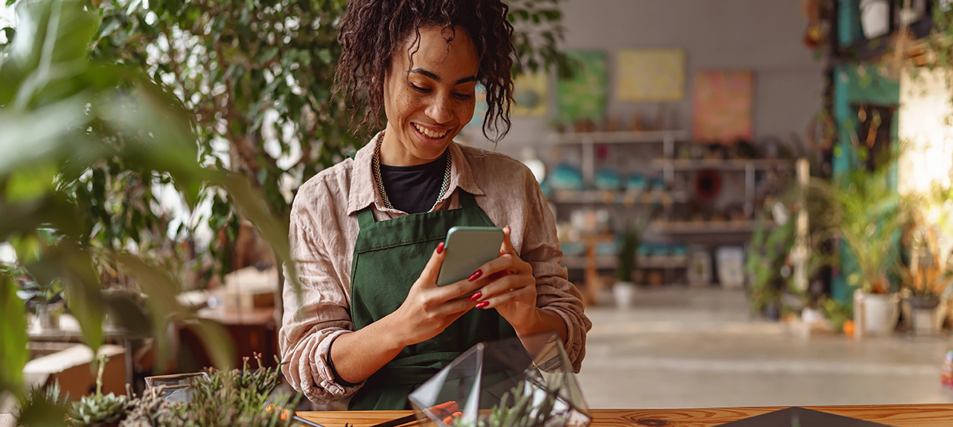 A plant store owner on her mobile phone