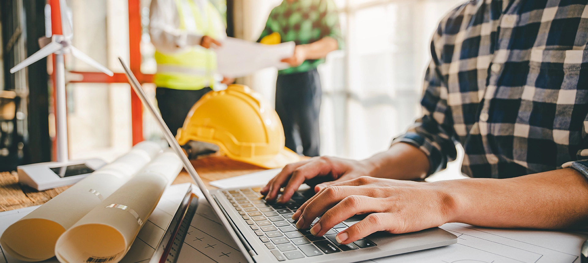 A construction worker on his laptop at a job site