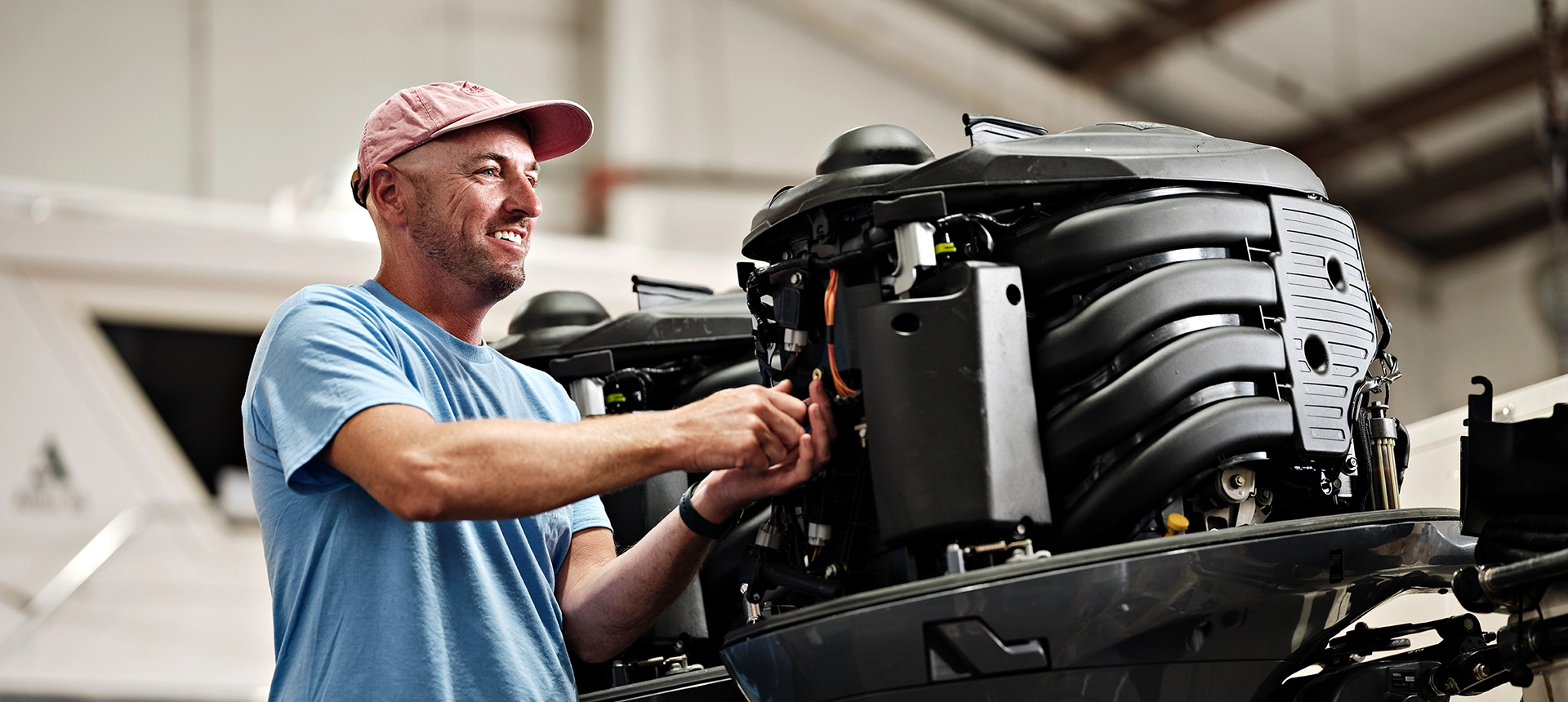 A man working on a boat engine