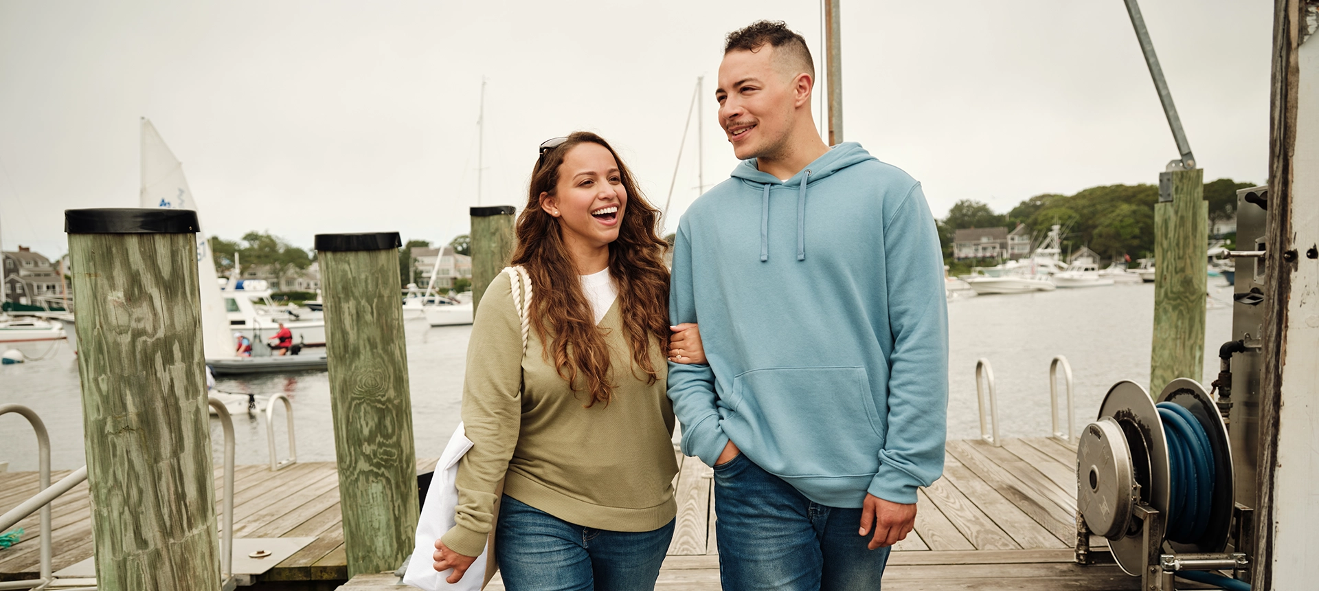 A couple walking down the dock over the water