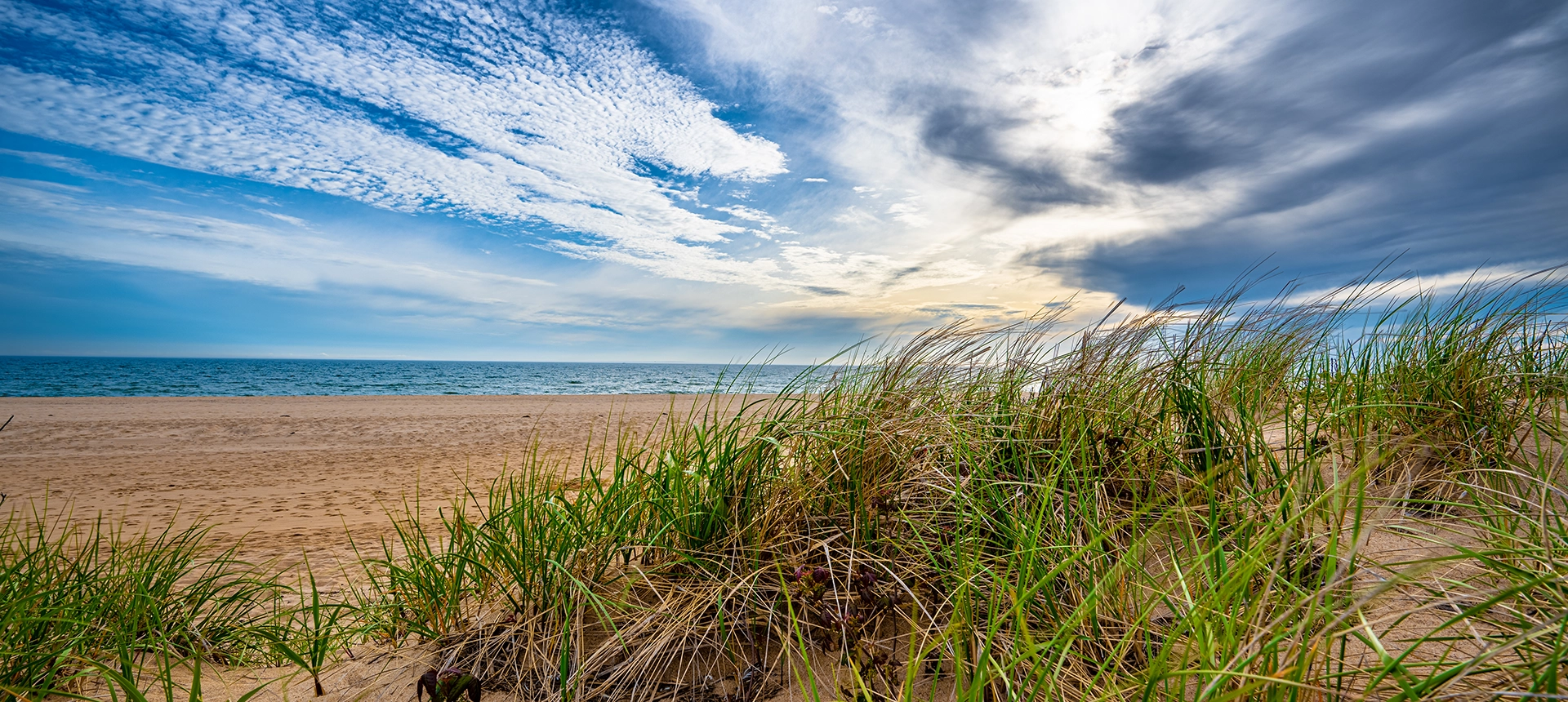 Image of the beach with the clouds moving quickly in the sky