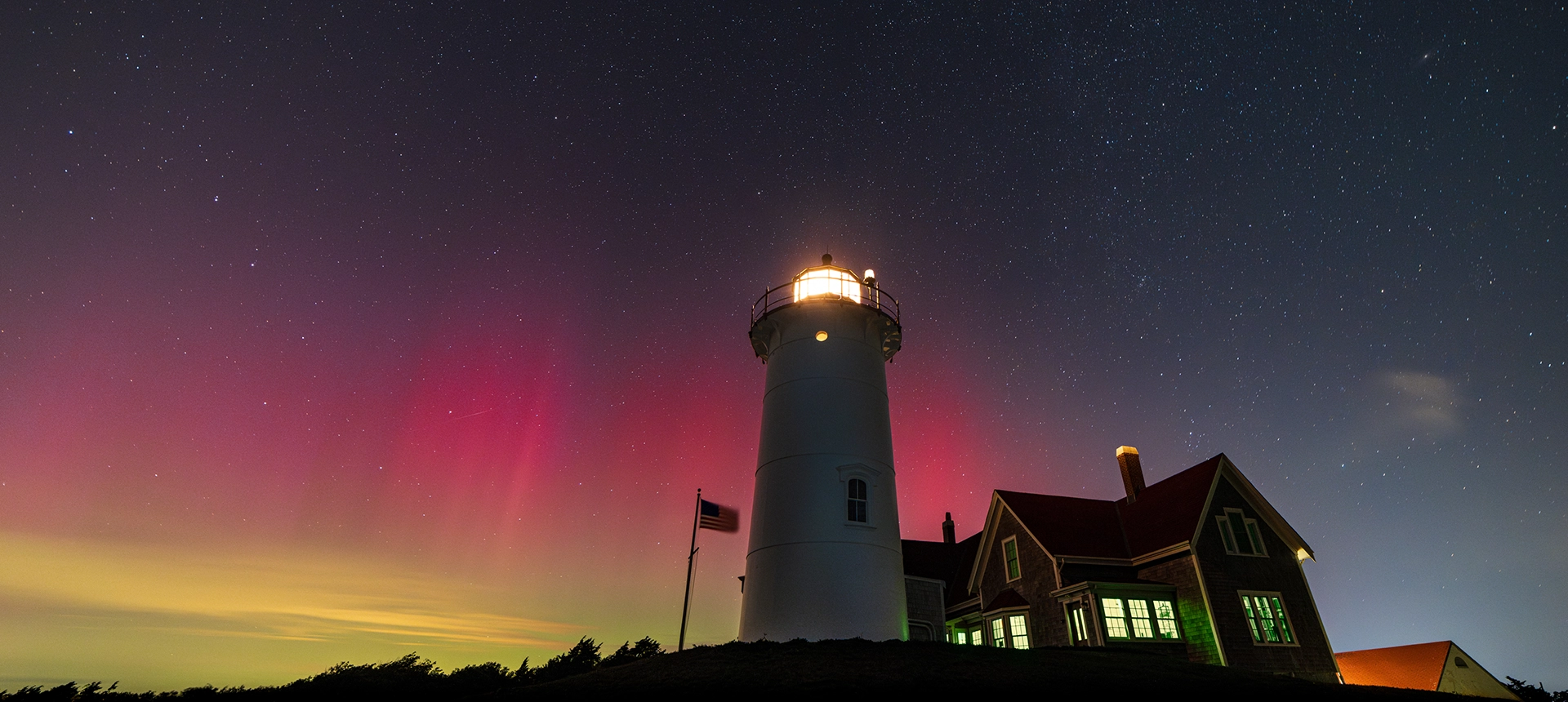 Cape Cod lighthouse with a sunset in the background