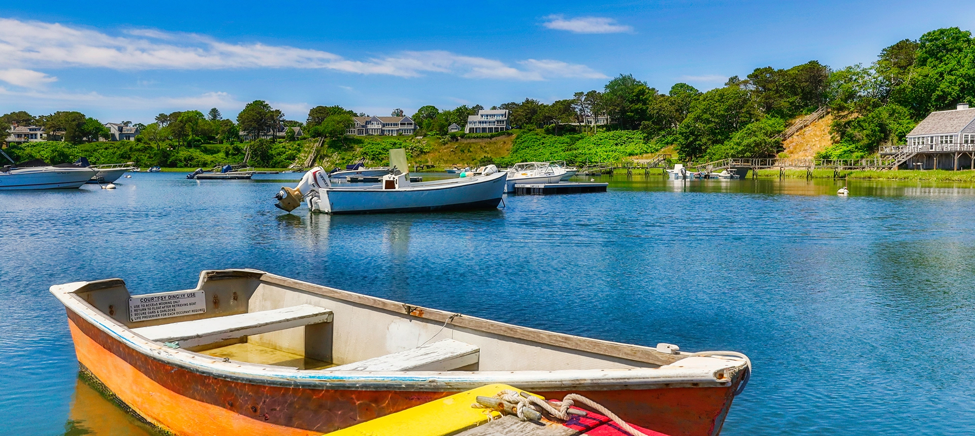 Colorful rowboats tied off on dock at Mill Pond.