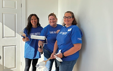Volunteers painting a house