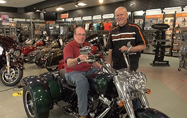 A man buying a motorcycle at a dealership