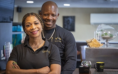 Business owners posing with their arms crossed