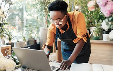 A flower shop employee on the computer