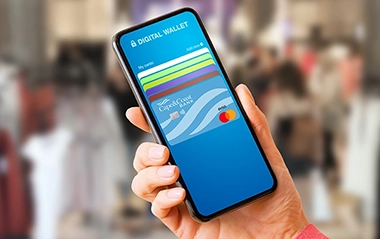 A person holding their cell phone with digital wallet on it