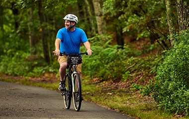 A man riding a bike down a path
