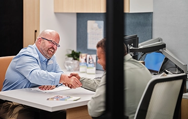 A Cape and Coast employee shaking a clients hand