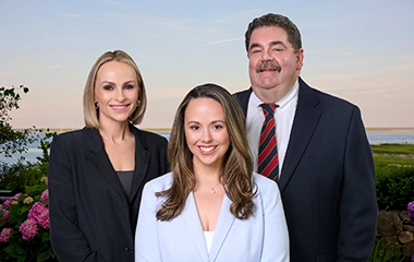 Cape & Coast Financial Investment team pose together, dressed professionally on beach background