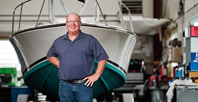 A man standing in front of his boat