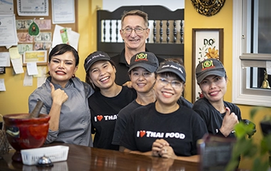Workers at a Thai restaurant posing for a picture