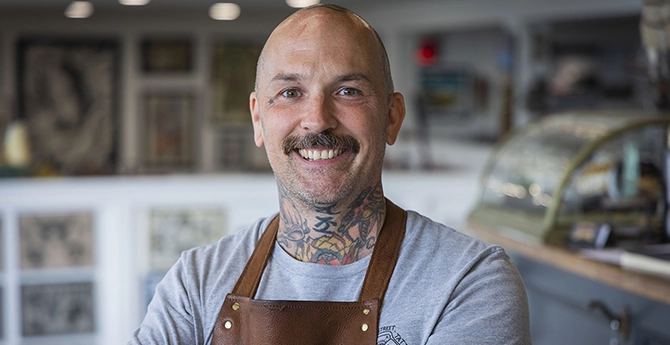 A small business owner smiling