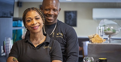 Business owners posing behind the counter